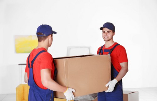 Movers loading office items carefully for transport in West London