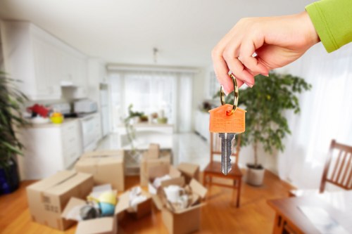 Professional packers organising household items room by room in a Holland Park property