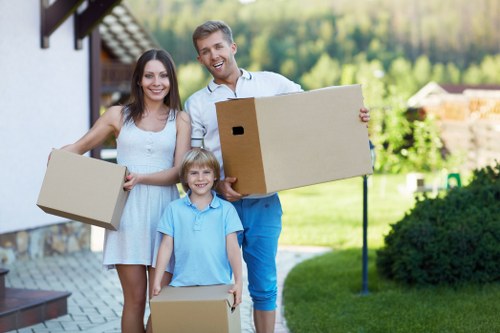 Local moving van handling furniture near Holland Park