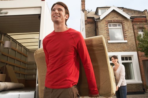 Furniture loading into a moving truck for Holland Park customers