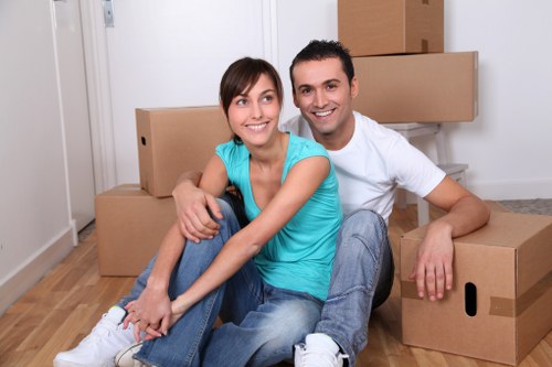 Professional office moving team handling furniture in Holland Park