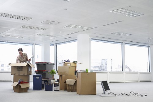 Careful wrapping of fragile items and furniture for a move in West London