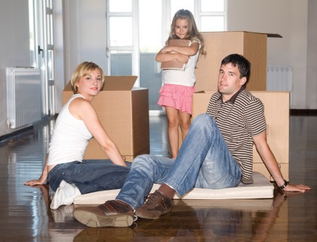 Crew using protective coverings while moving furniture
